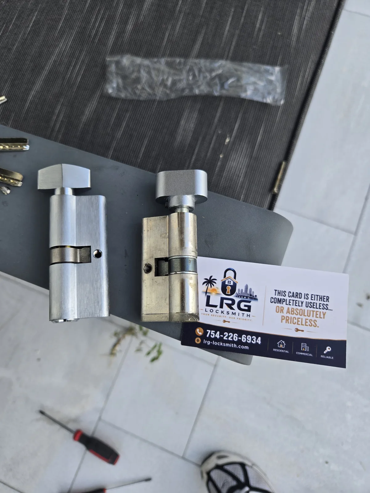 New and old high-security Euro cylinders during a locksmith replacement