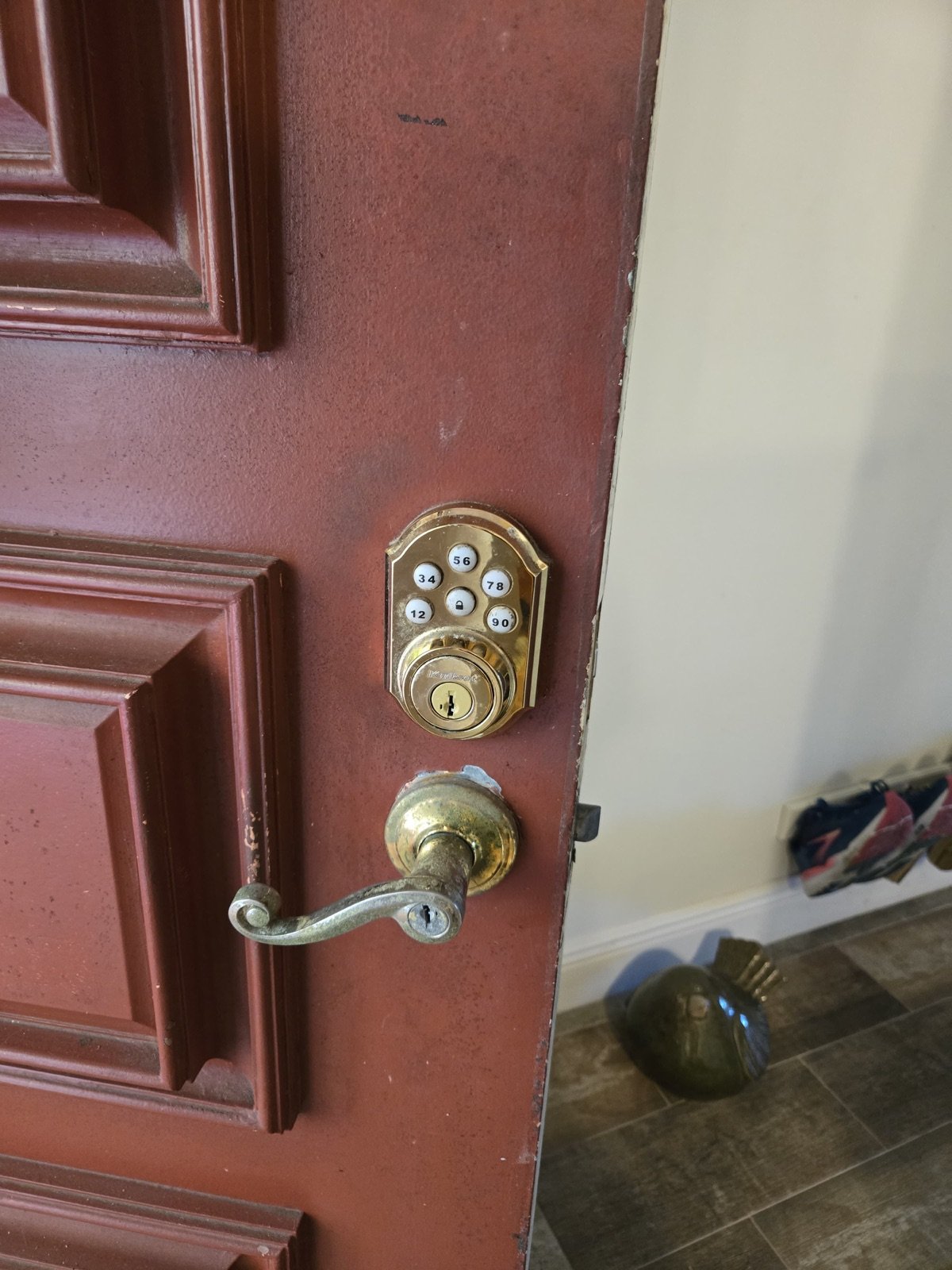 Old keypad deadbolt and lever before residential lock replacement