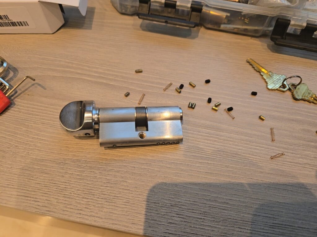 Disassembled lock cylinder with pins and springs during rekeying